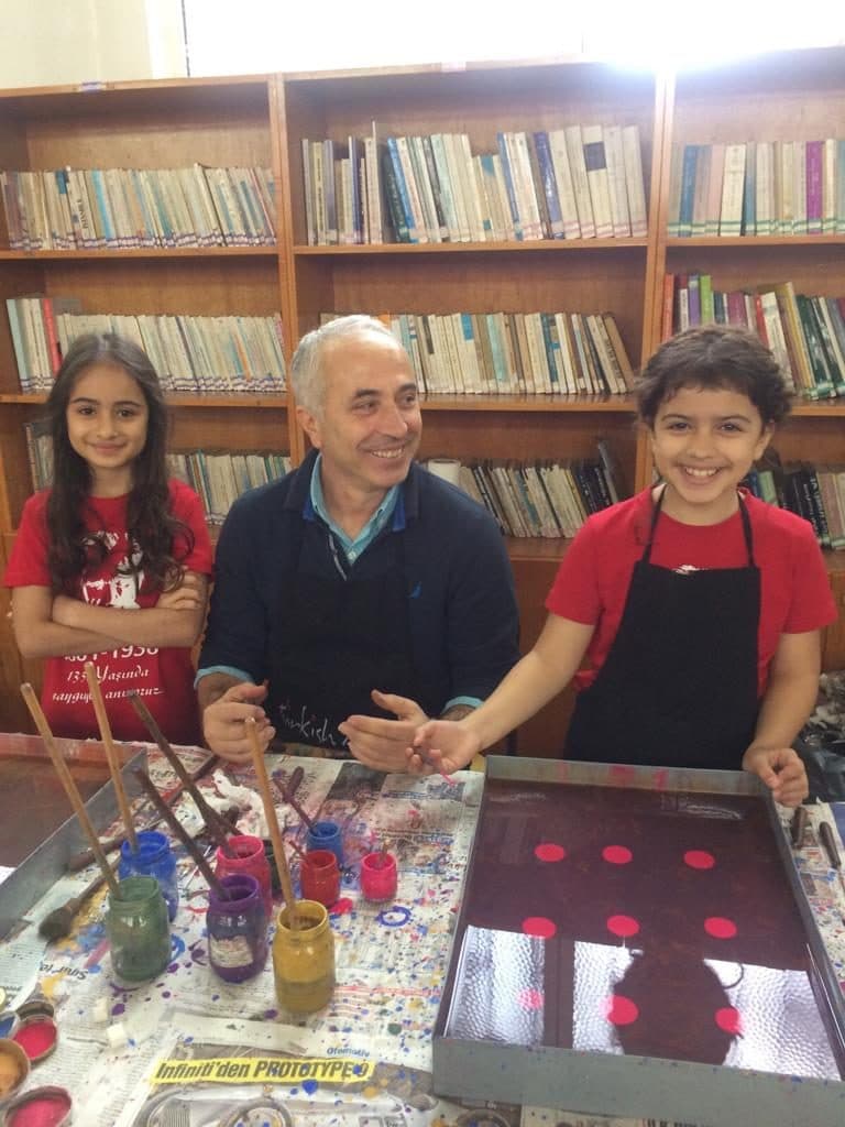A family holding their framed marbling artworks